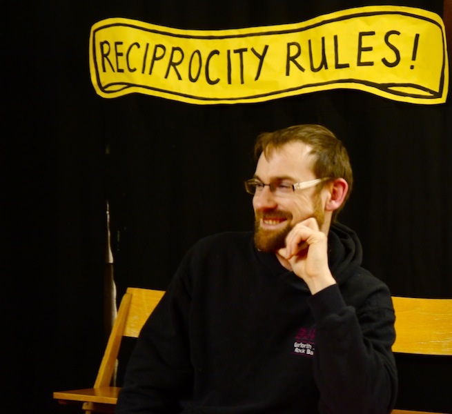 Reprocity Rules! A photo including this banner and a red-haired, bearded man (Leeds Creative Timebank)